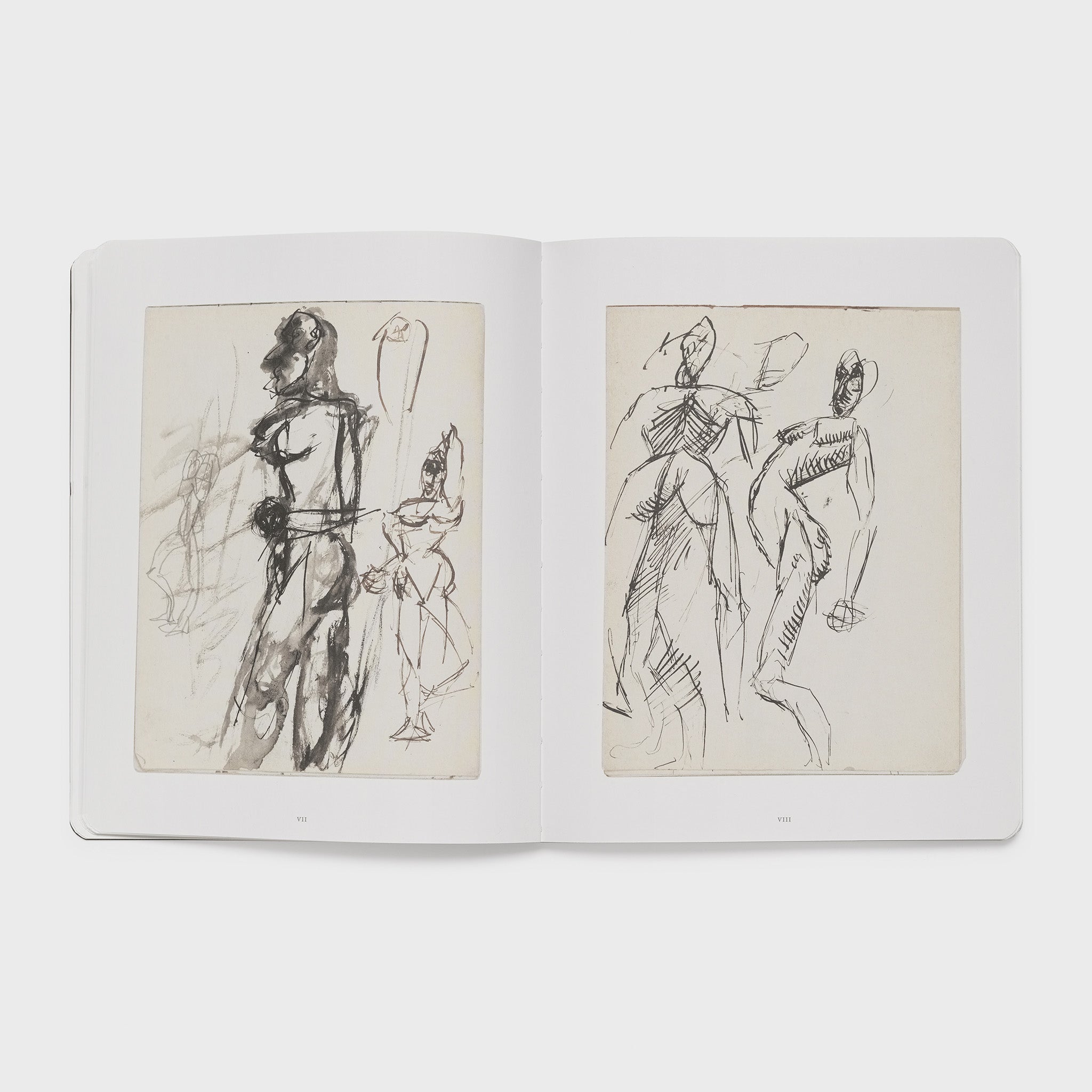 The book is open to two pages. Each page has an image of a drawing from the artist in his notebook done in black ink.
