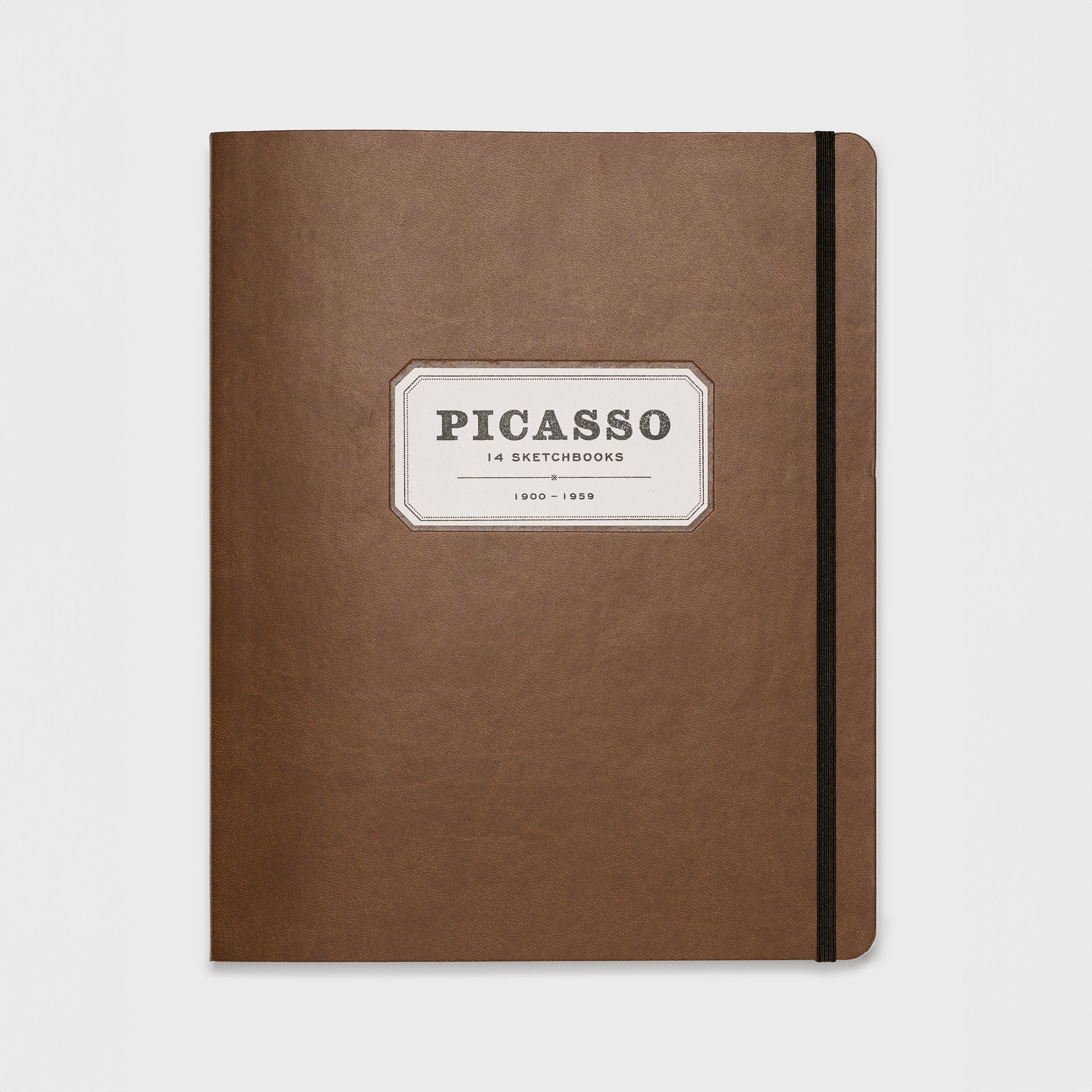 Picasso 14 Sketchbooks 1900-1959. The background is brown leather and has a brown strap to keep the book closed.