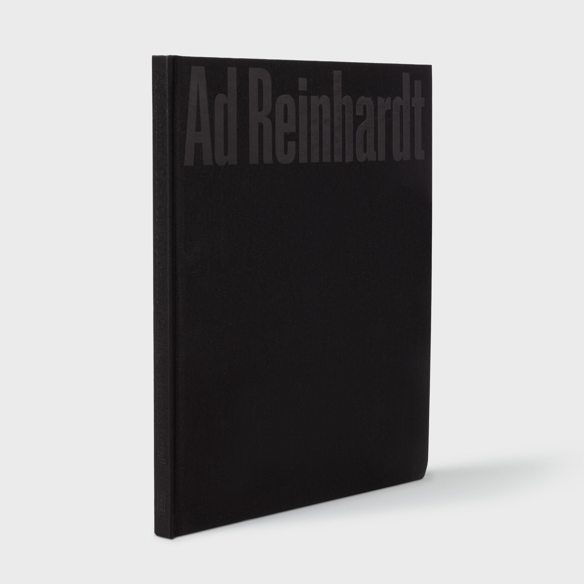 Ad Reinhardt: Color Out of Darkness, Curated by James Turrell book standing upright. Black cloth cover with black text.