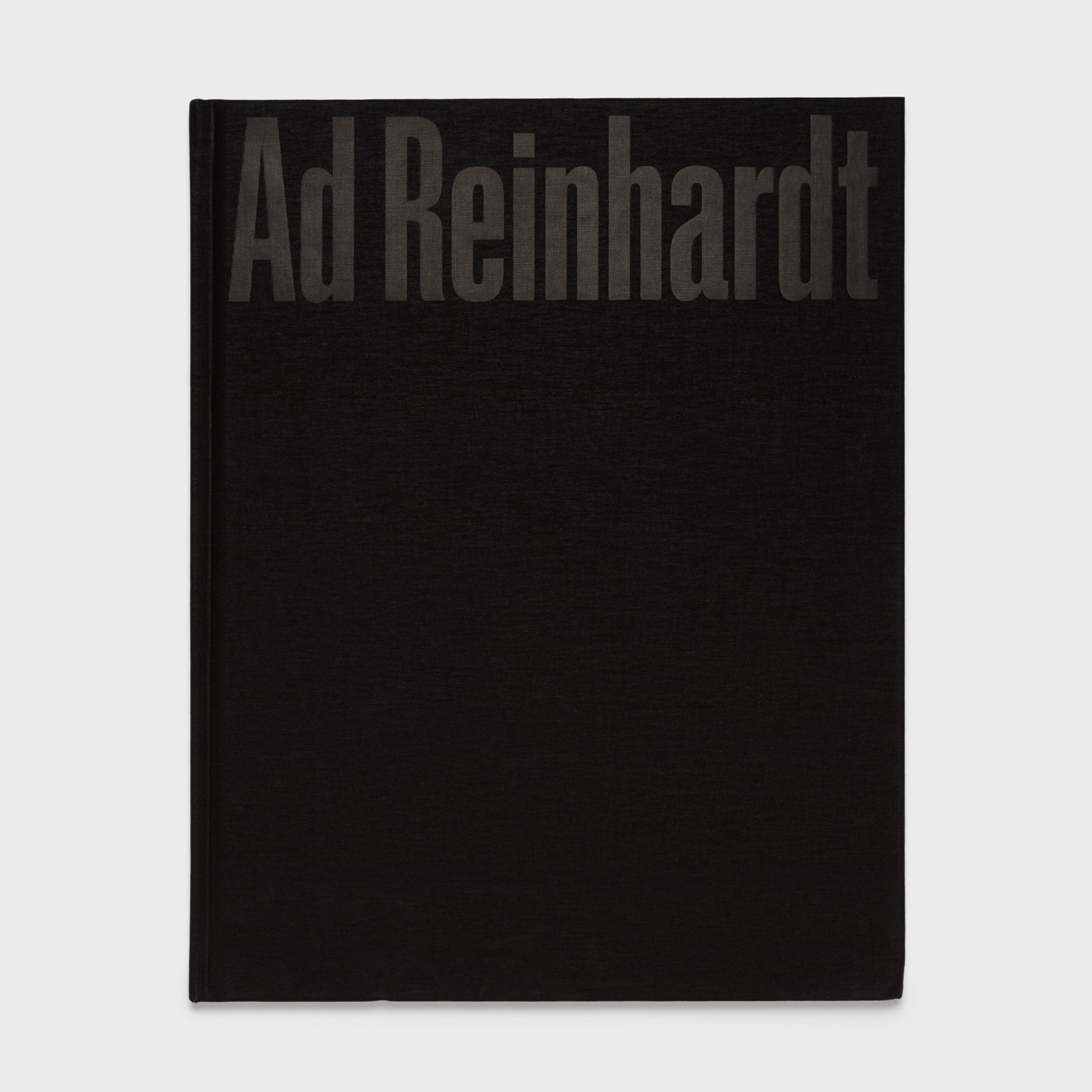 Ad Reinhardt: Color Out of Darkness, Curated by James Turrell book standing upright. Black cloth cover with black text.