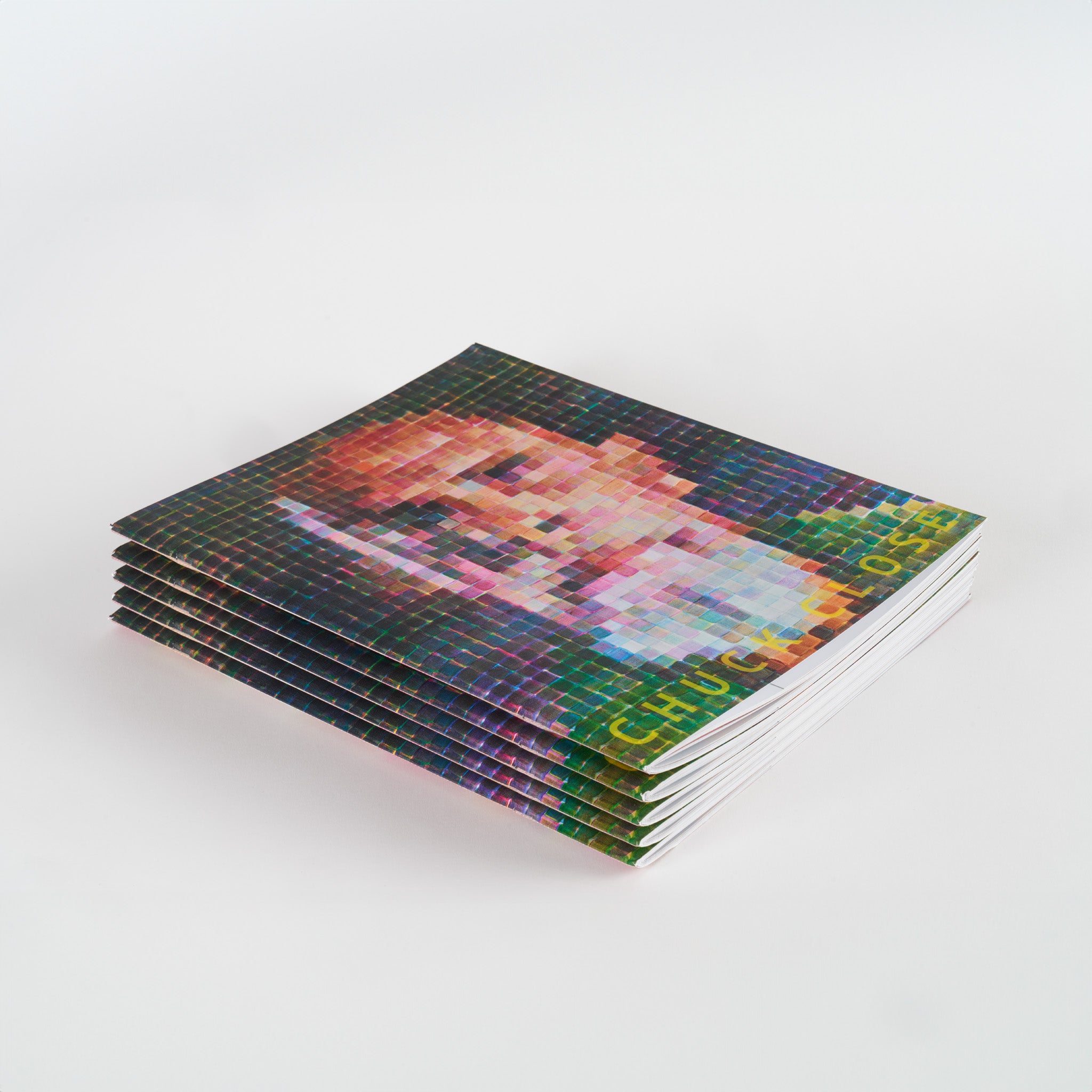 A stack of five Chuck Close books.