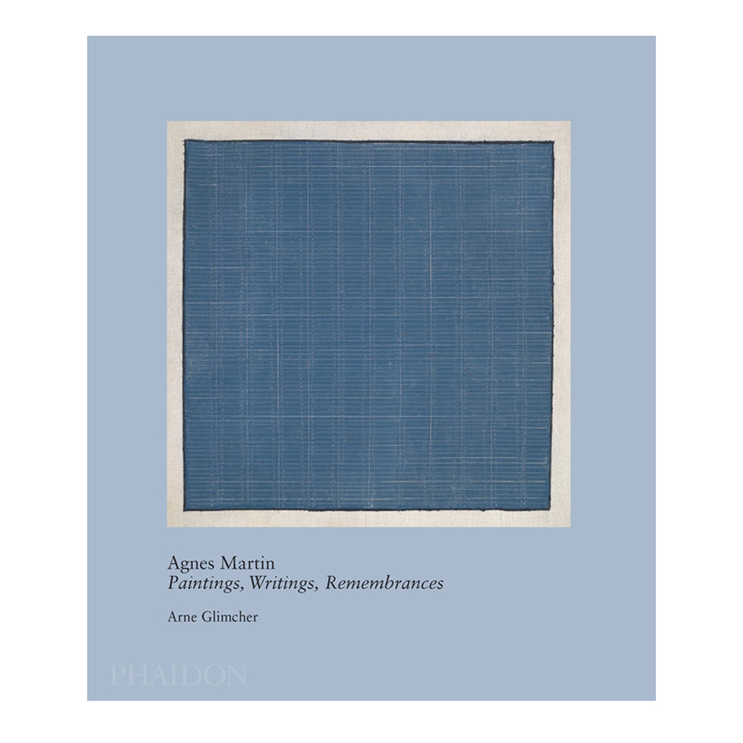 Agnes Martin Paintings, Writings, Remembrances by Arne Glimcher. The blue book is upright with a blue Agnes Martin painting on the cover.