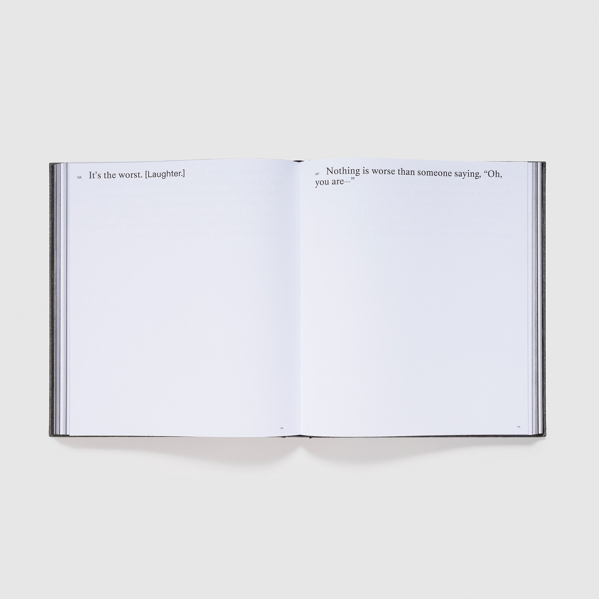 The book is open to two pages with an interview between the two artists in black font.