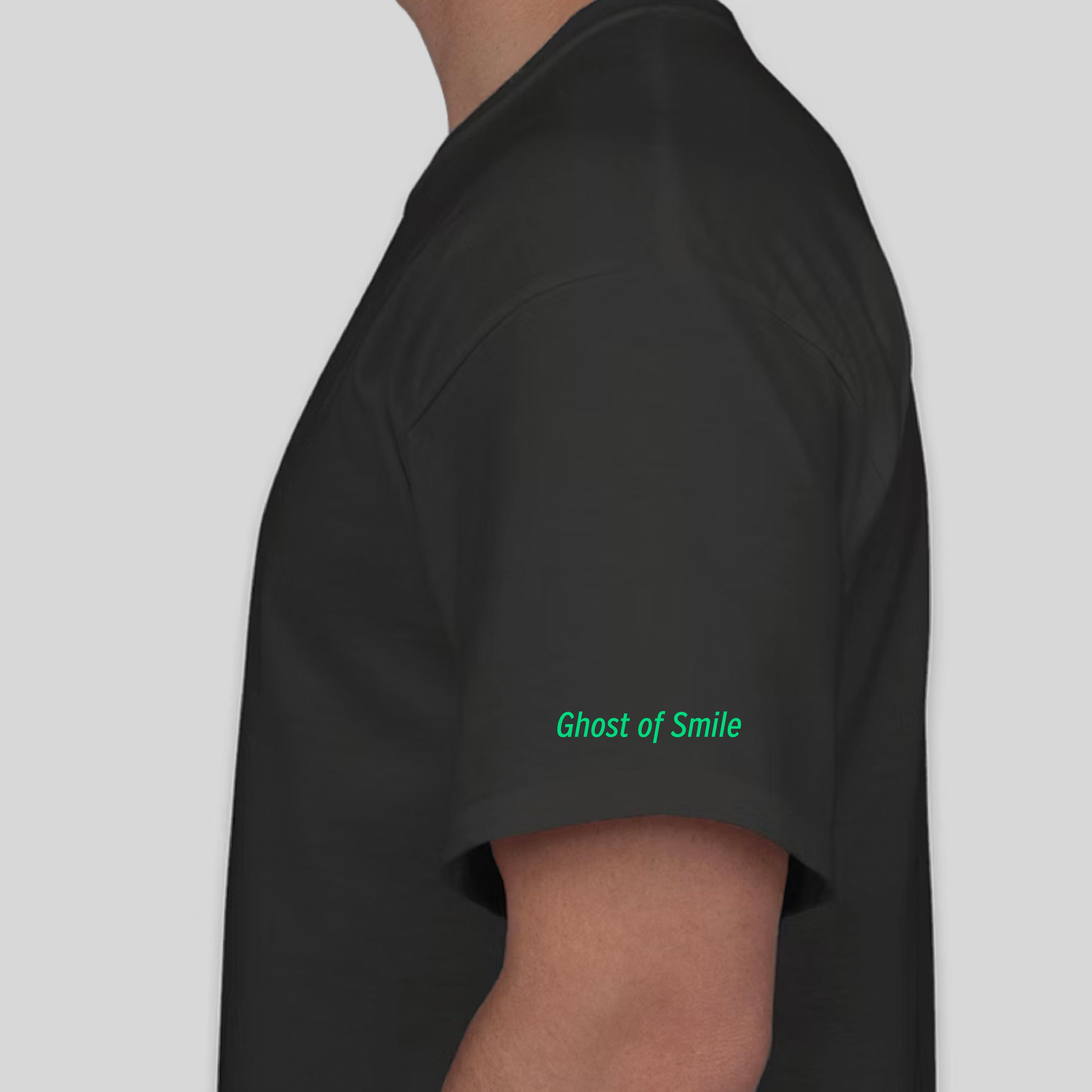 The model is standing sideways with the sleeve of the shirt visible. The black tshirt reads Ghost of a Smile on the sleeve.