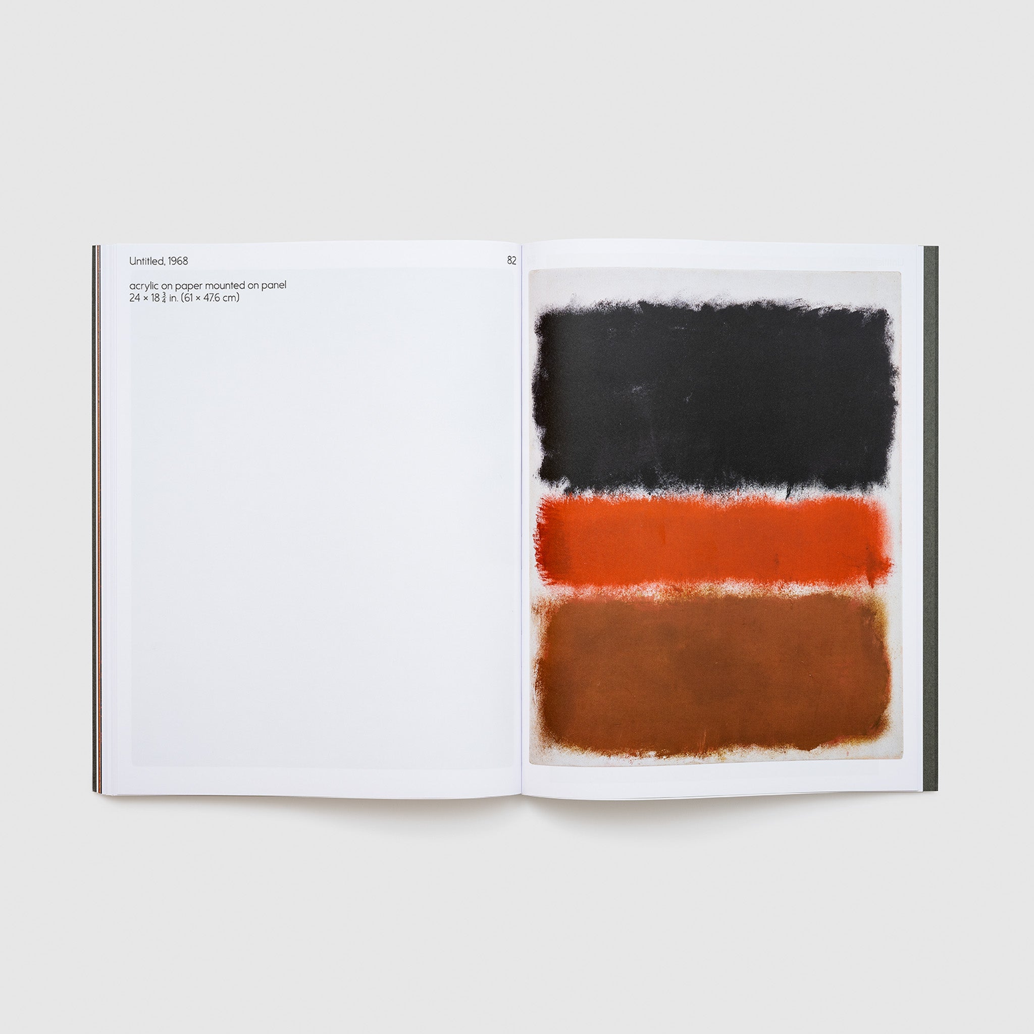 The book is open to two pages. The right page has a black, red, and brown Rothko work. The left page has a description of the work.
