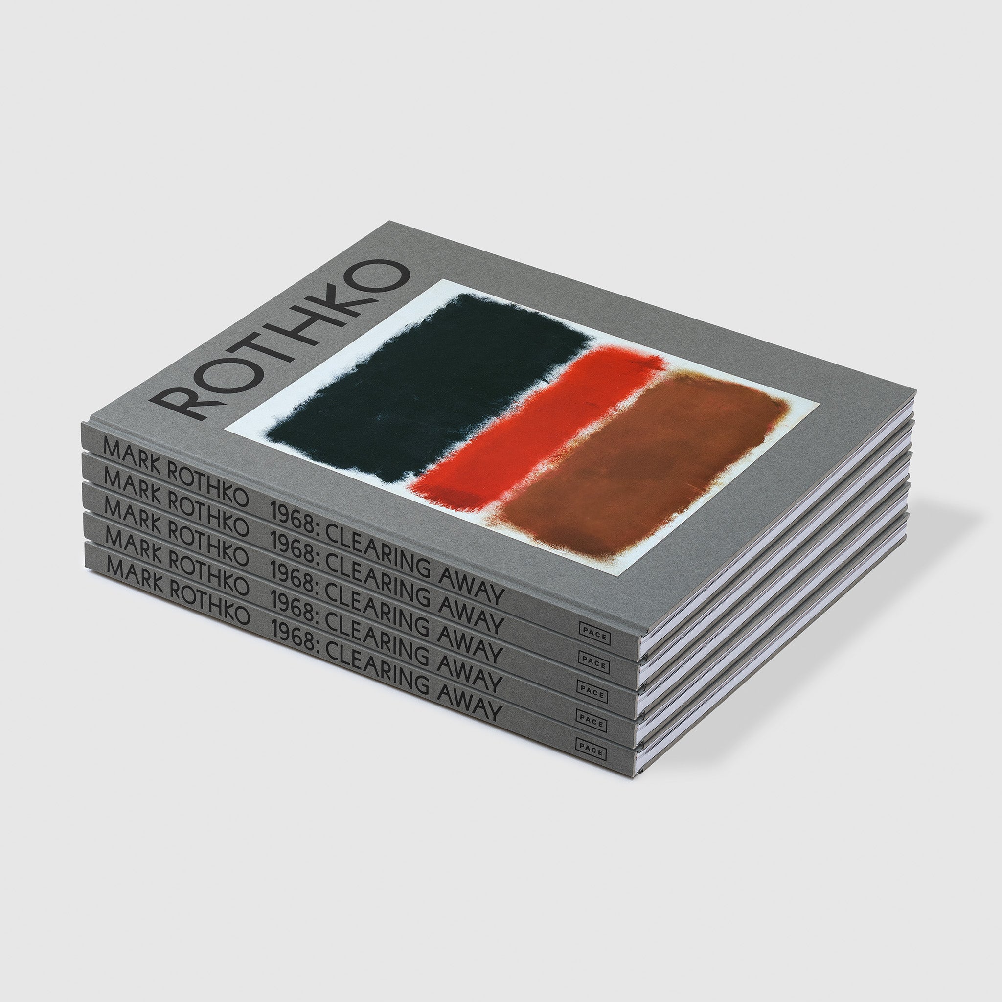 There is a pile of five Rothko 1968: Clearing Away books stacked on top of each other. The covers are grey with a black, red, brown, and white Rothko painting on them.