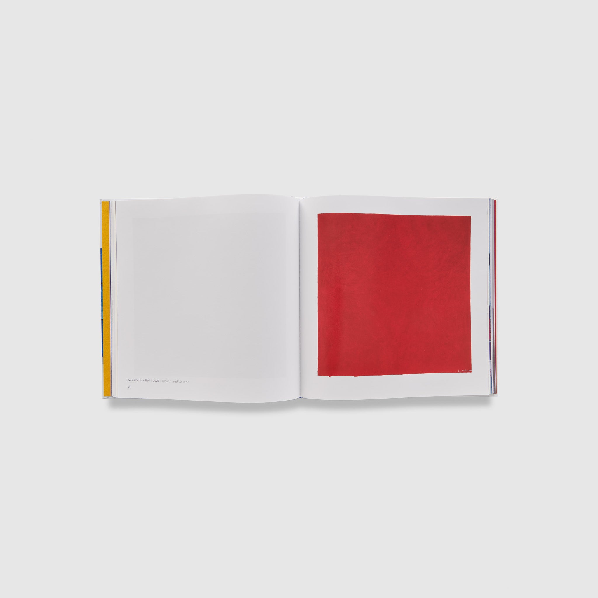 The book is open to two pages. A red work by the artist is on the right page and the description is on the left.