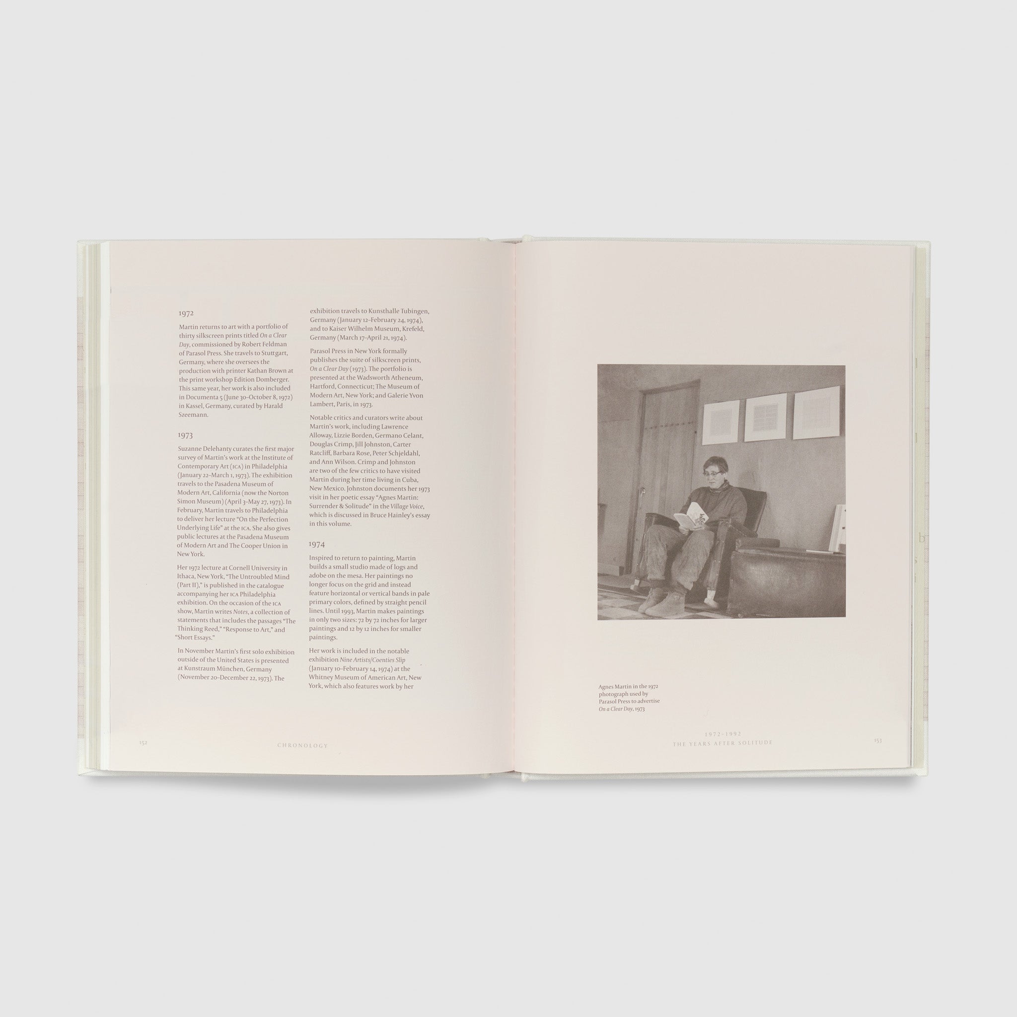The book is open to two pages. The right page has a black and white photograph of Agnes Martin and the left page has a timeline of significant events in the artists life.