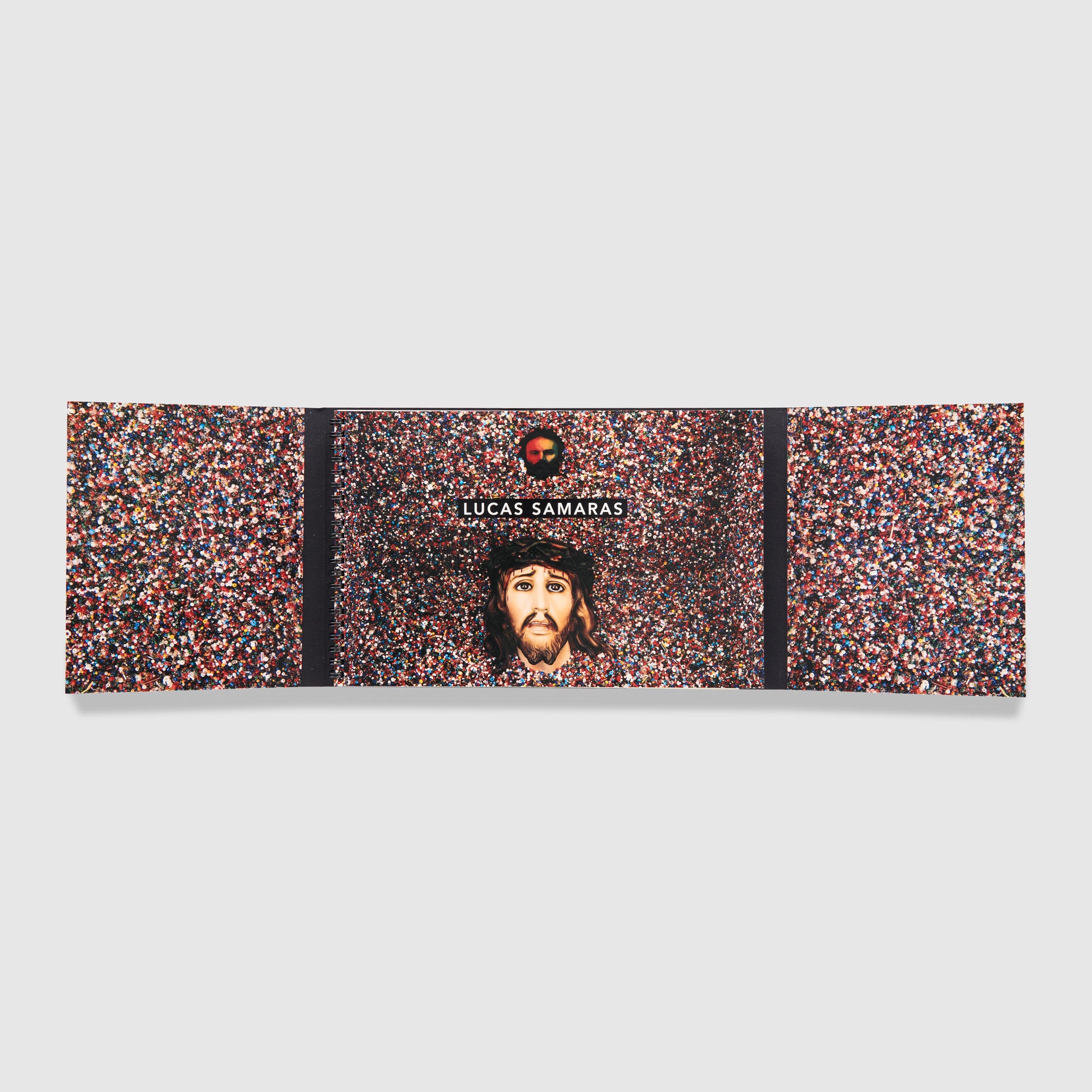 The book is open with an image of a colorful Samaras work across the pages and foldouts.