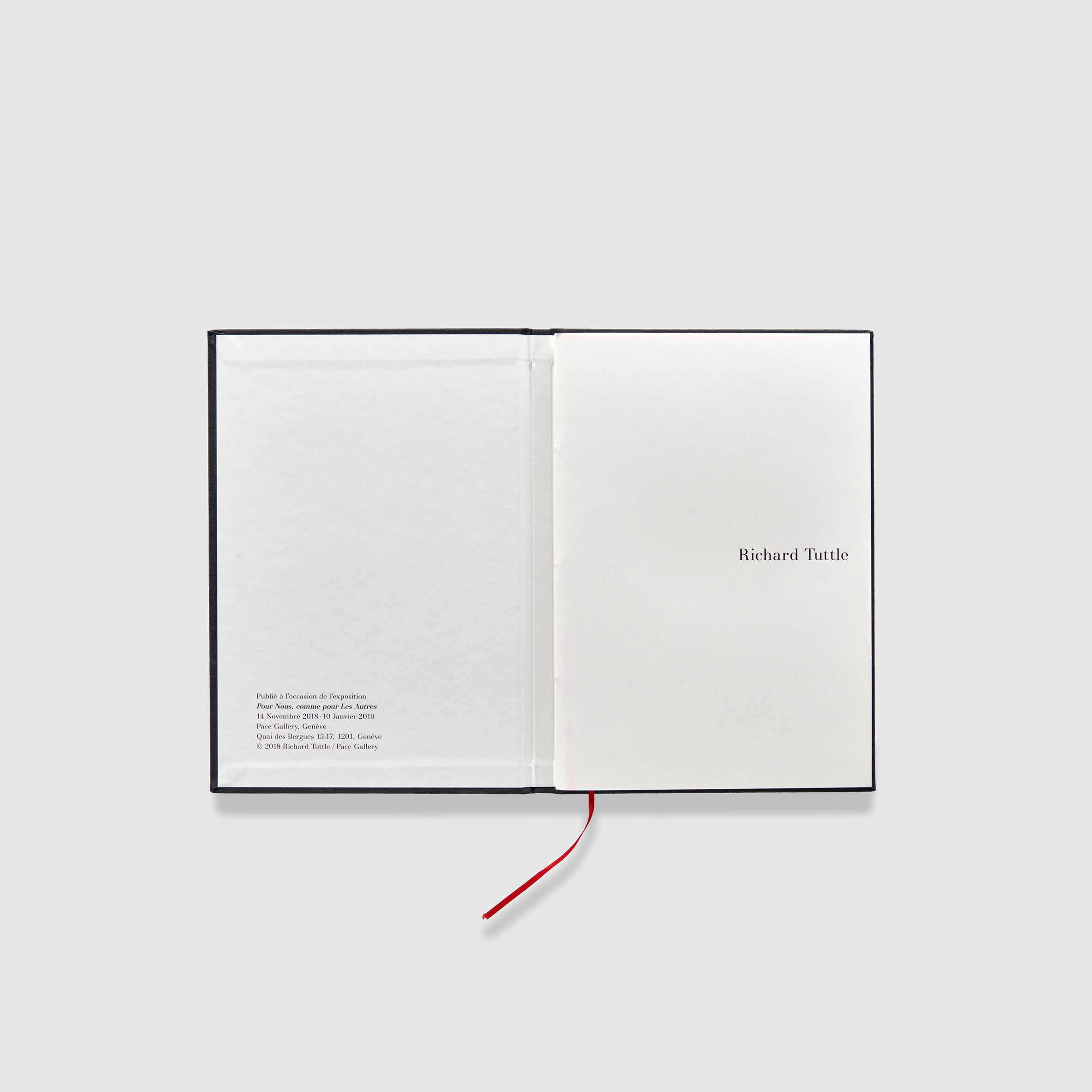 The book is open to two pages. The right page is the first page of the book and the left pages has the publication information.