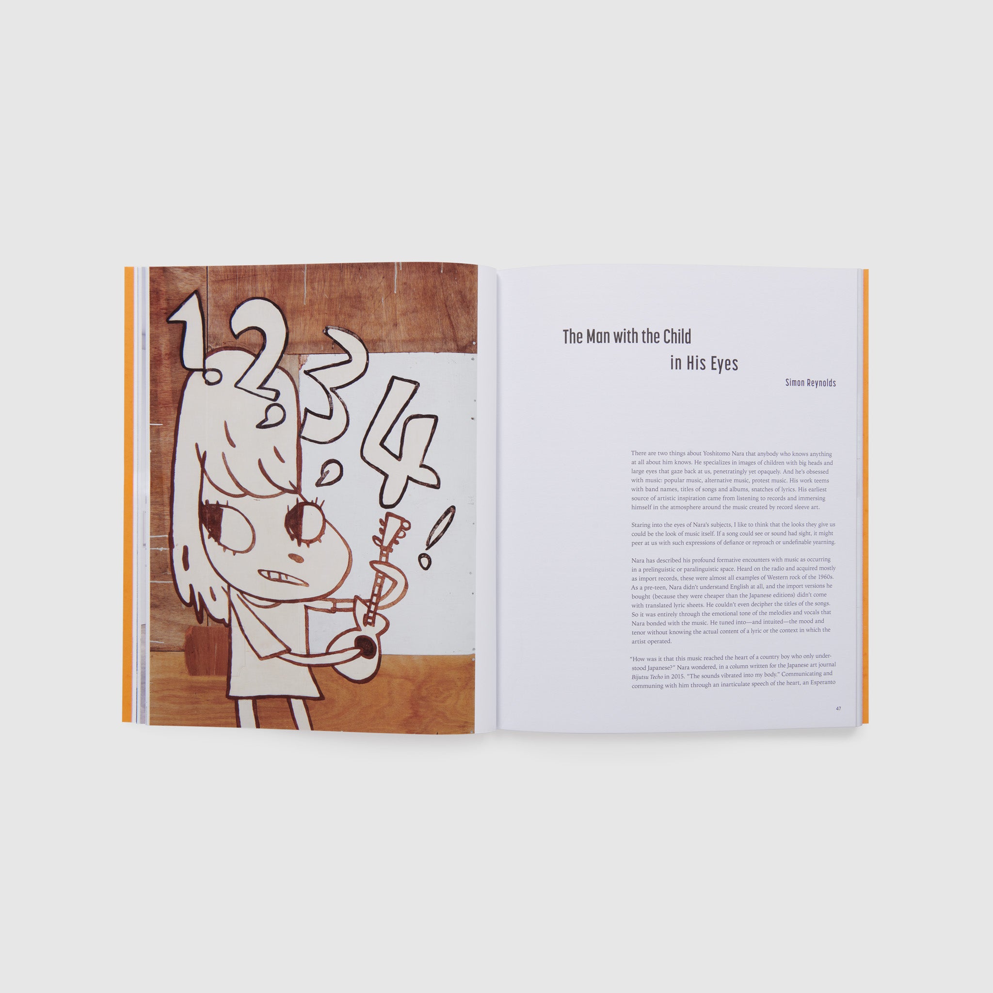 The book is open to two pages. The left page has a brown, white, and black Nara work. The right page has an essay.
