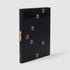 Mika Tajima. The book has a black cover with gold hot tub nozzle details.