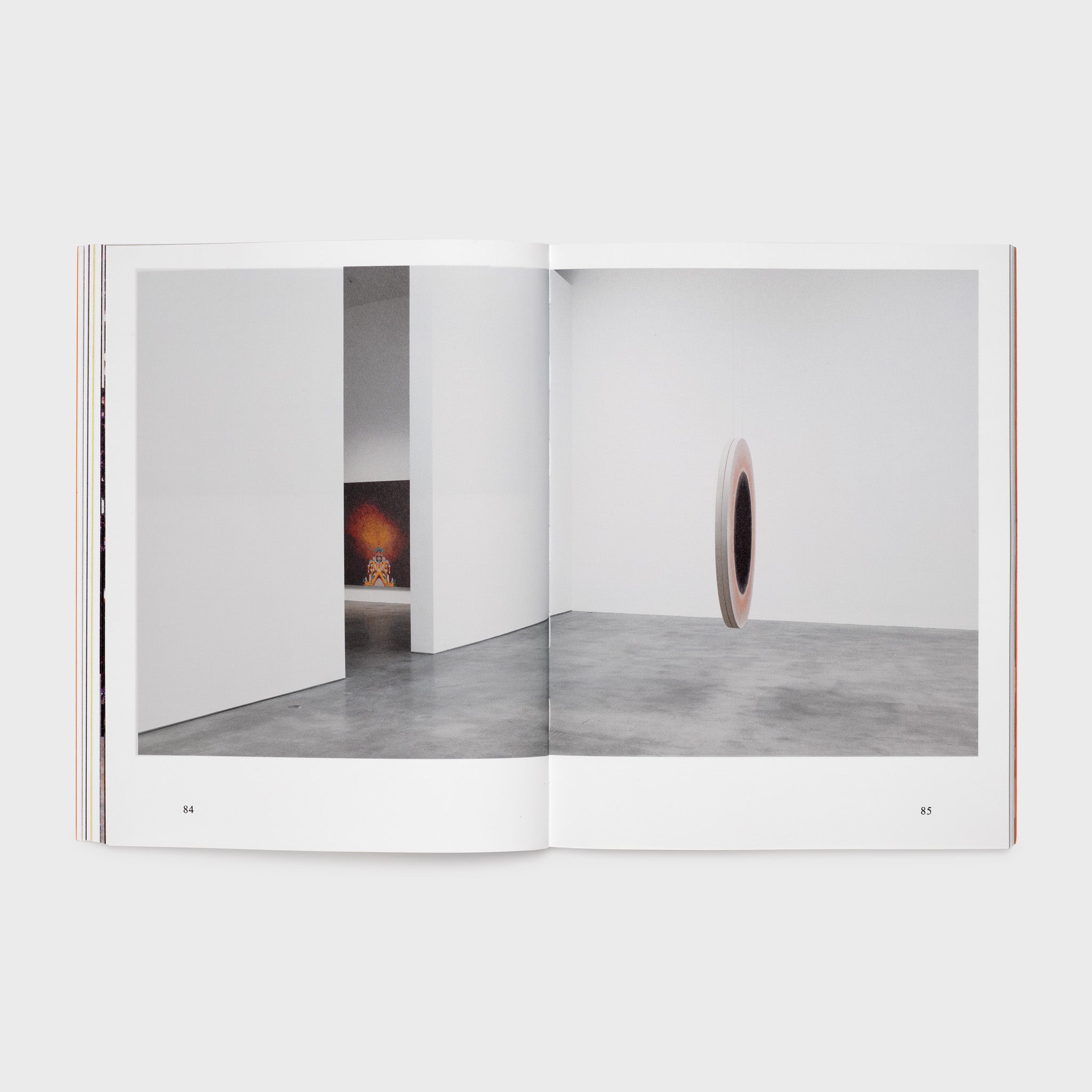 The book is open to two pages. There is one photograph across both pages. It is of the gallery installation of the Monk exhibition.