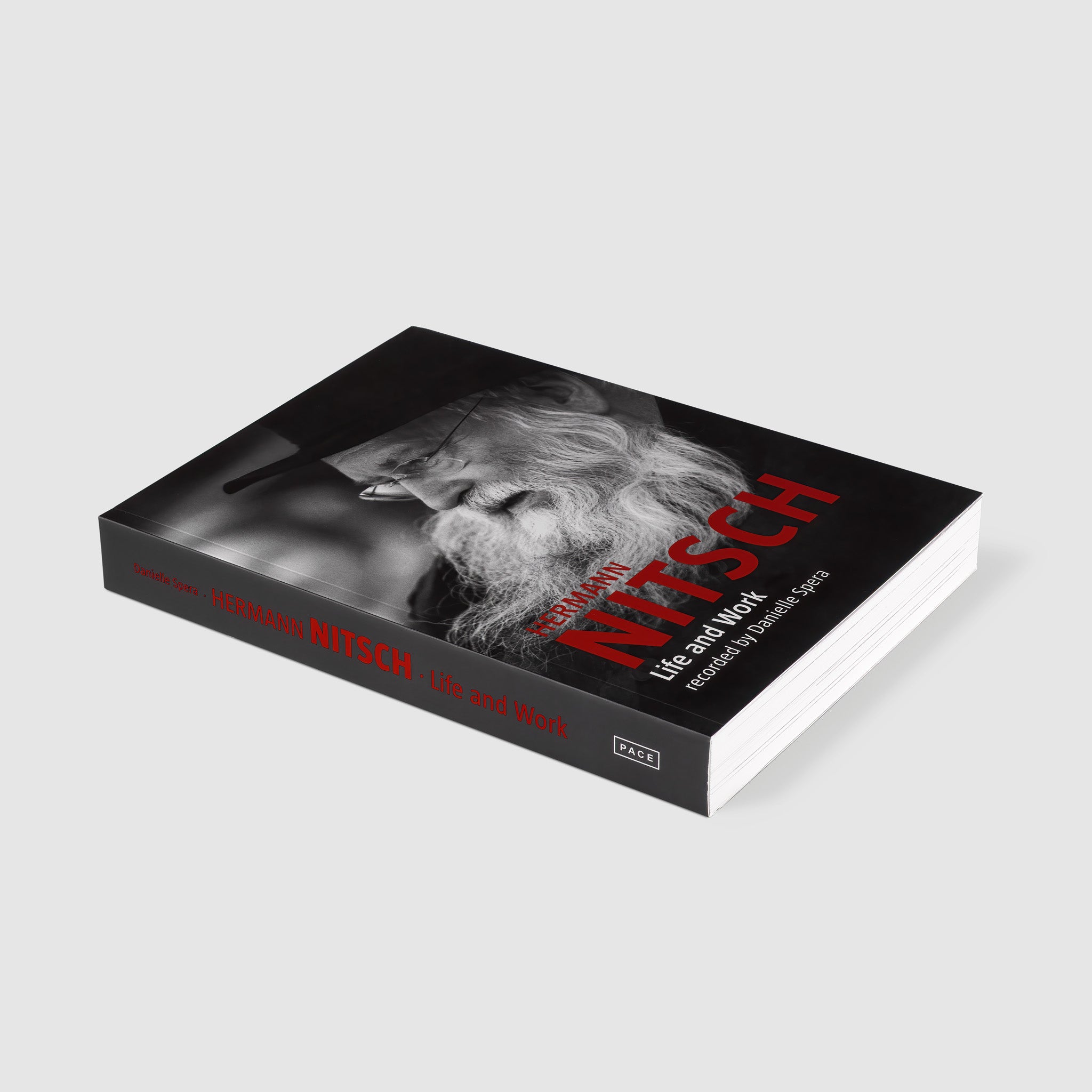 Hermann Nitsch Life and Work recorded by Danielle Spera. The cover is black with red and white text. There is a black and white image of the artist.