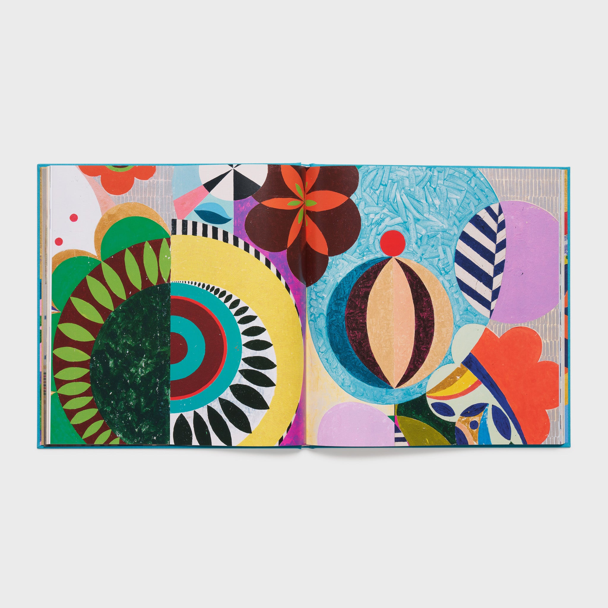 The book is open to two pages with Milhazes&