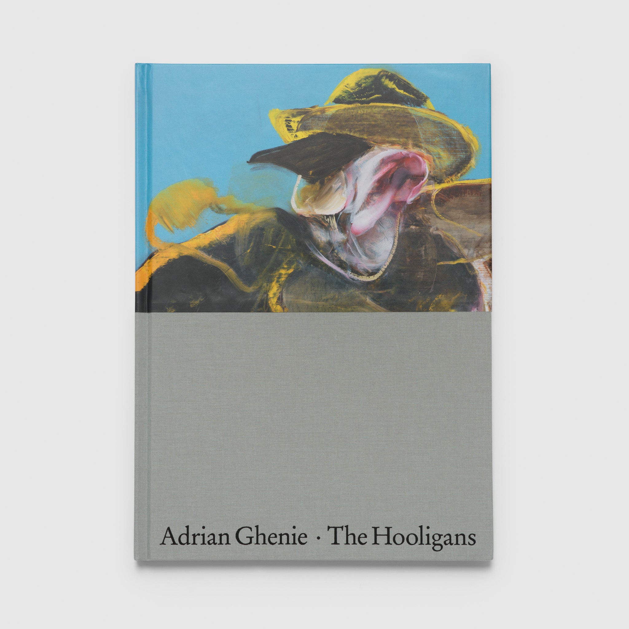 Adrian Ghenie The Hoolidans by Apsara DiQuinzio, Masha Tupitsyn. The book is upright and has the artists blue, yellow, and black painting at the top with grey cloth and black text on the bottom.