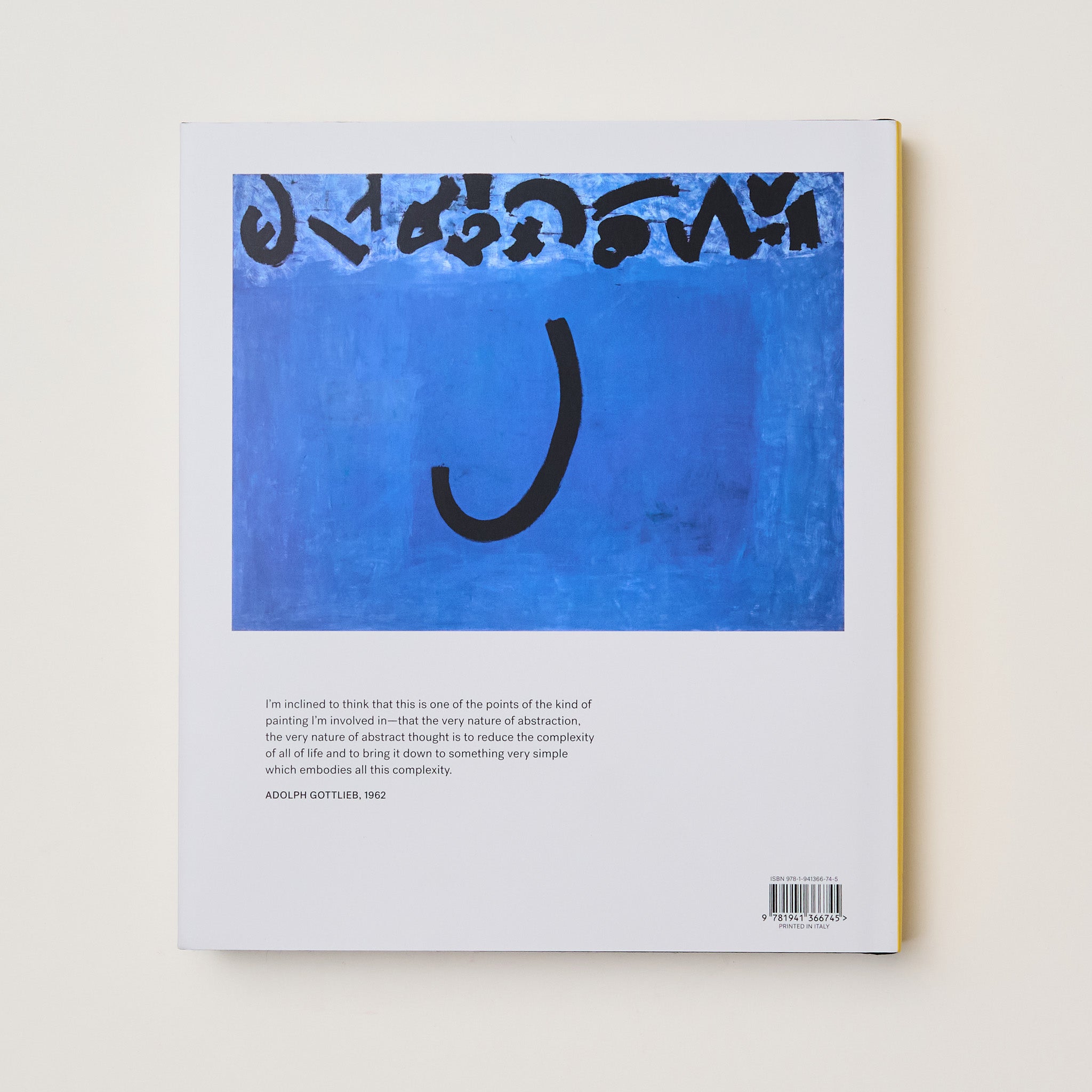The back of the book has a blue and black Gottlieb painting printed on it. There is a quote from Gottlieb printed in black on the bottom of the back cover.