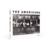 The book cover is white with the title "The Americans" in black letters. There is a black and white photo by Robert Frank on the cover.