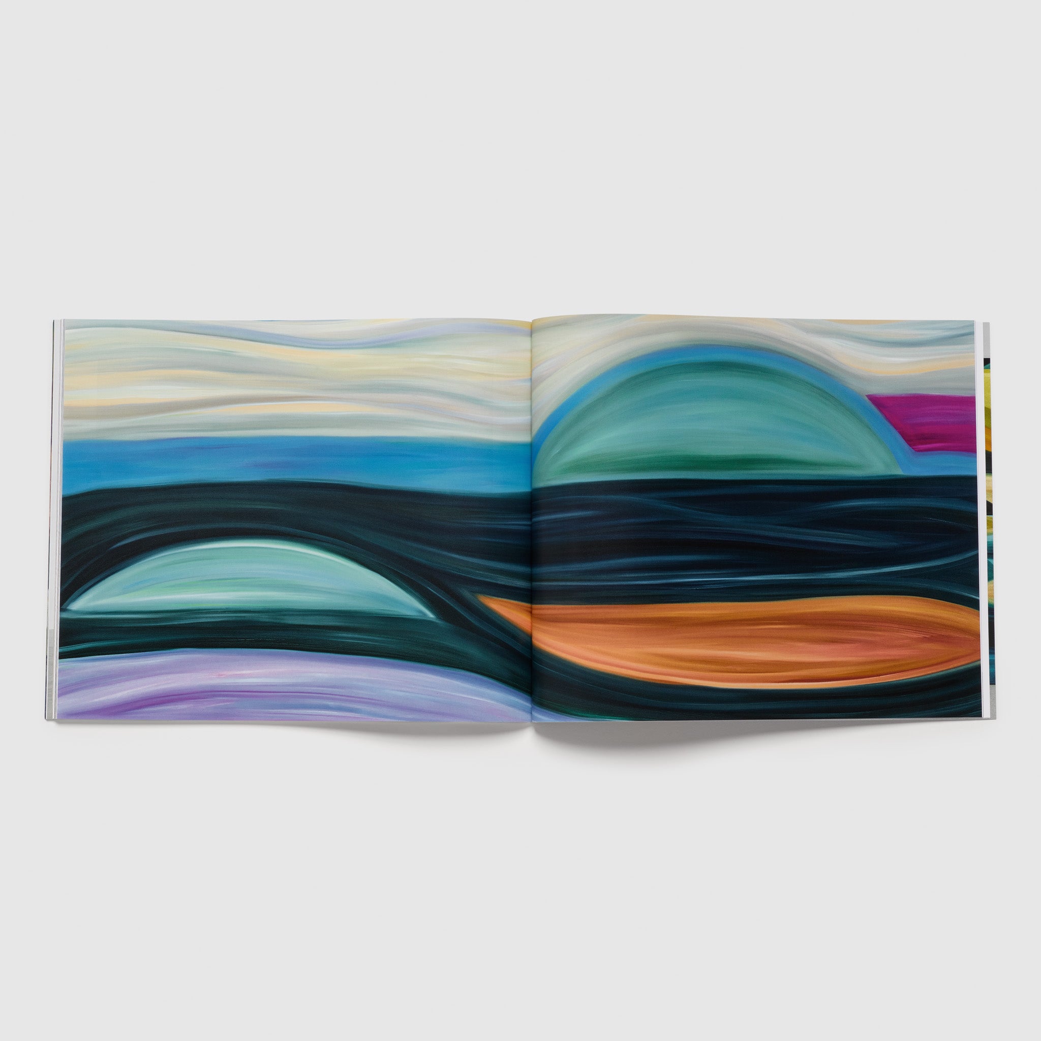 The book is open to two pages with a photograph of one Perez Simao work on both pages. The work is colorful and contains oranges, blues, pinks, and yellows.