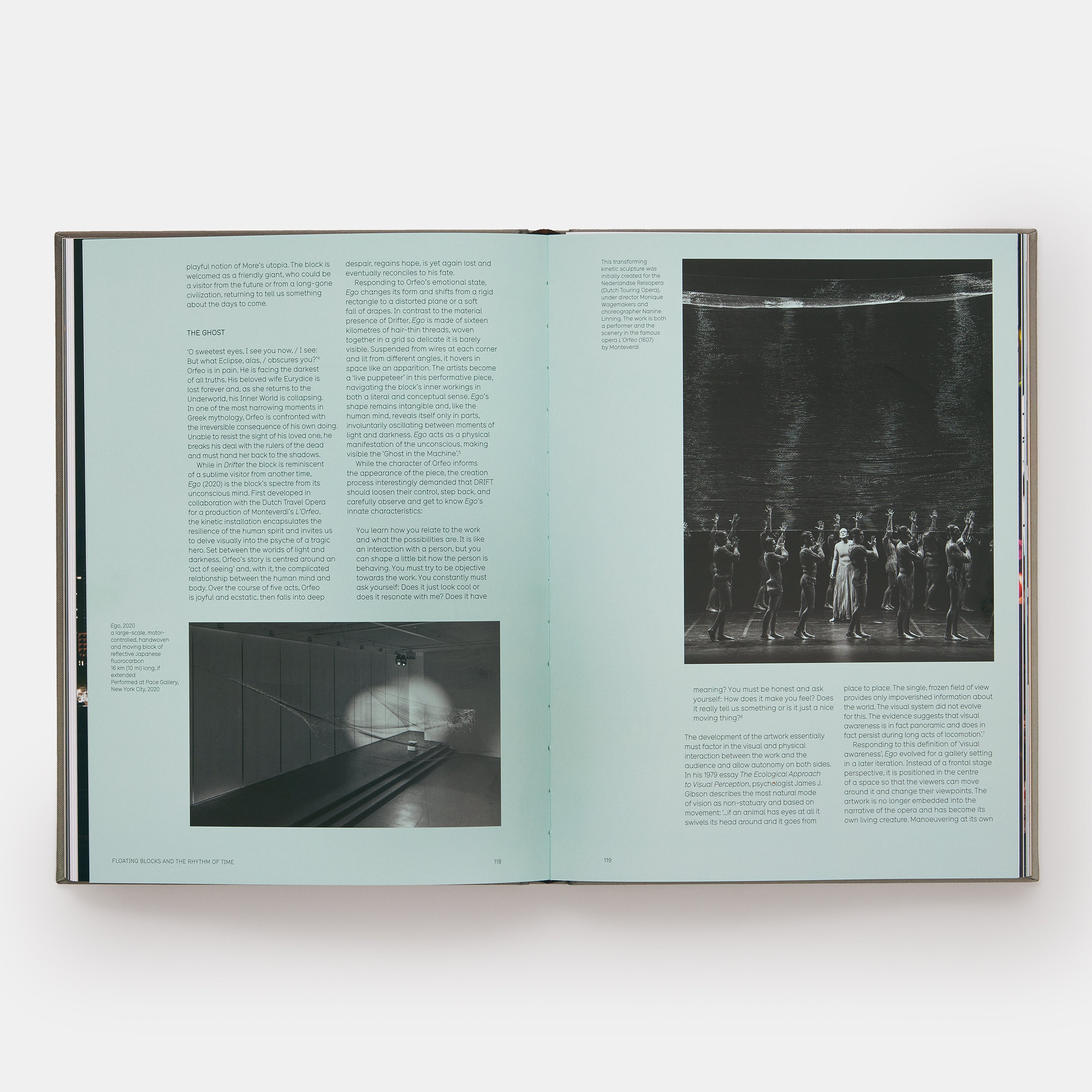 The book is open to two pages. The background is light blue with black and white photographs of Drift work on both pages.