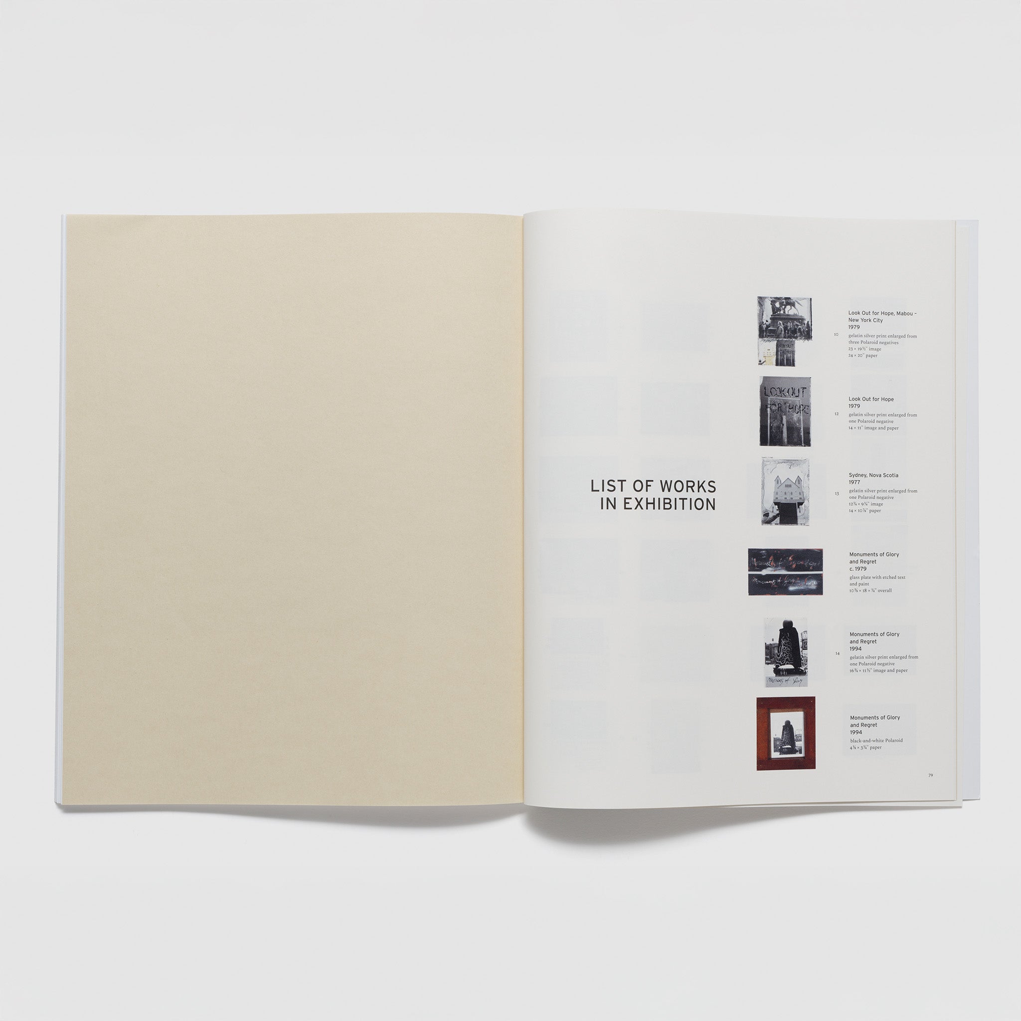 The book is open to two pages. The left page is blank and the right page has a list of works in the exhibition.