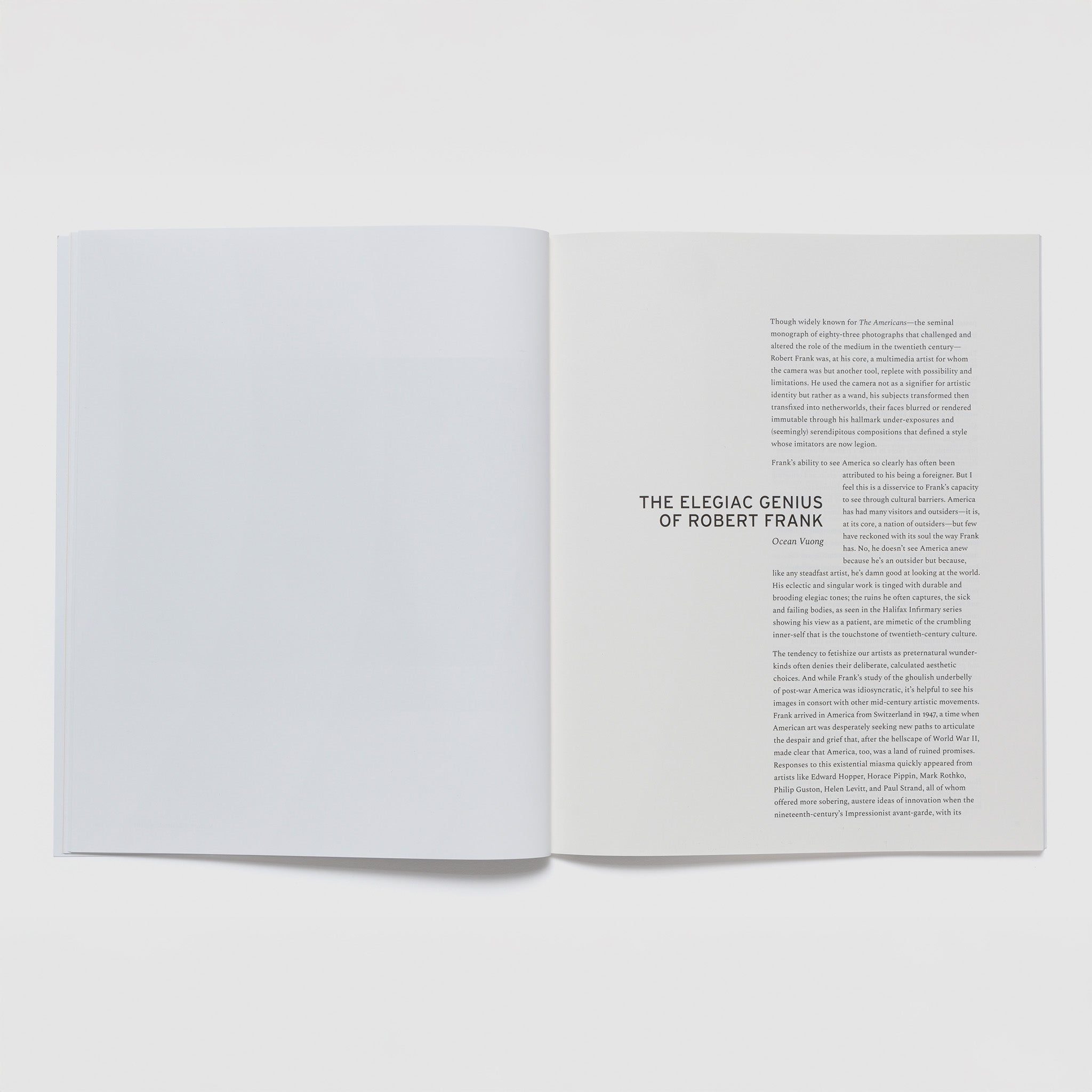 The book is open to two pages. The left page is blank and the right page has an essay.