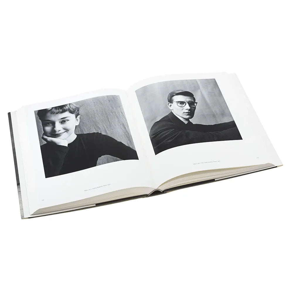 The book is open to two pages, with a black and white portrait on each page.