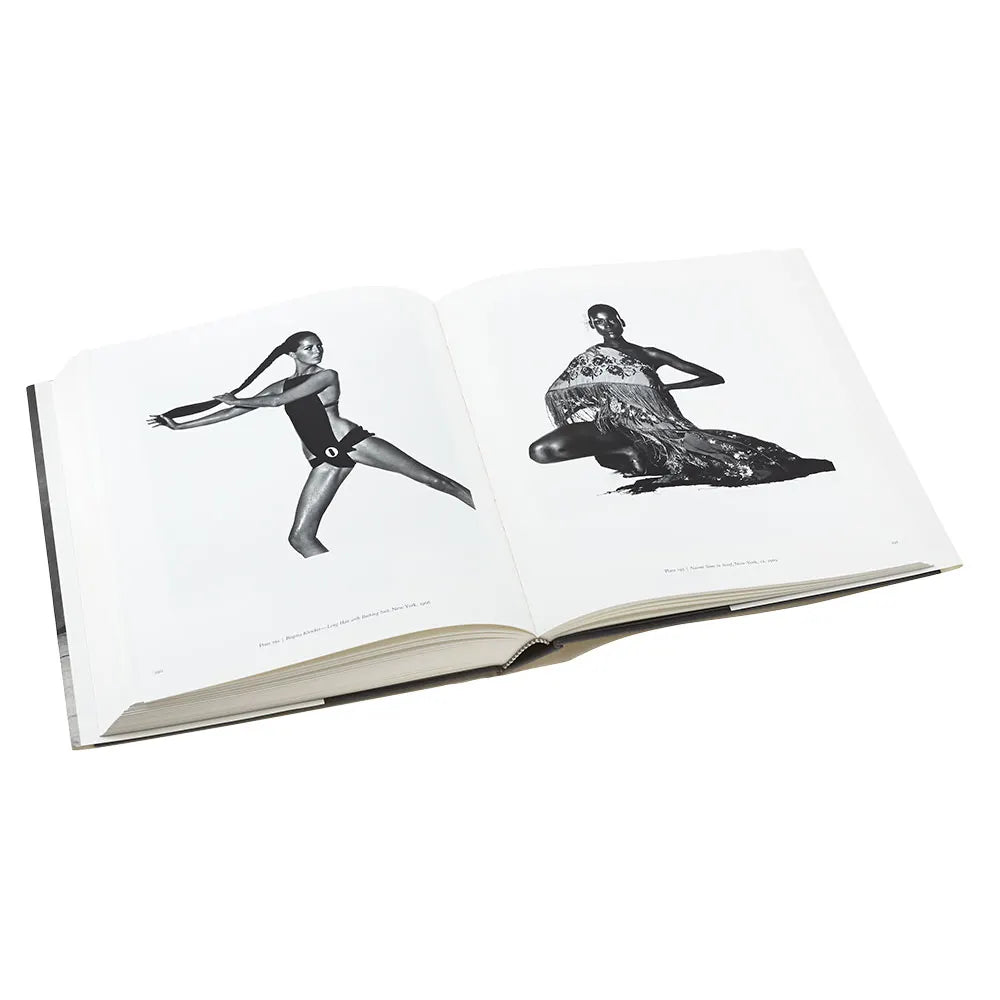 The book is open to two pages with a black and white photo by the artist on each page.
