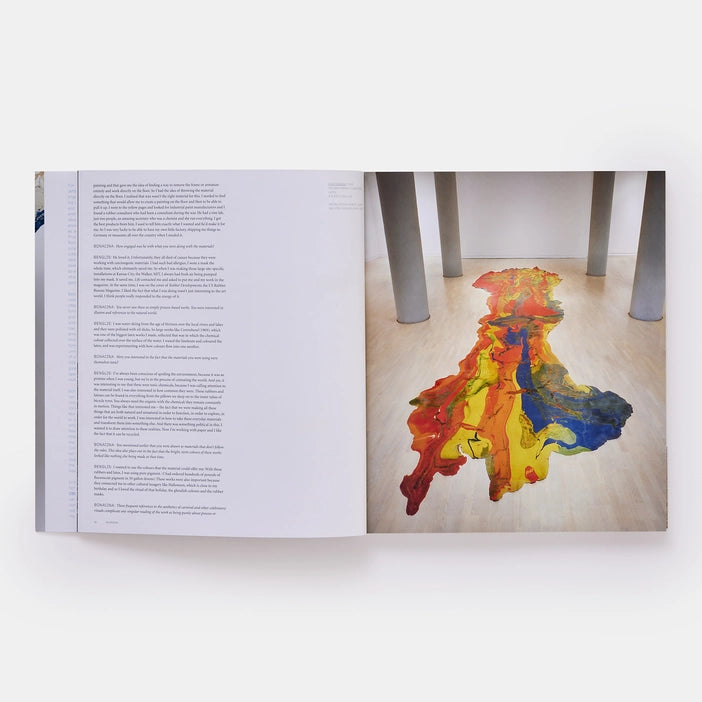 The book is open to two pages. The right page has a photograph of a Benglis work and the left page has an interview with the artist.