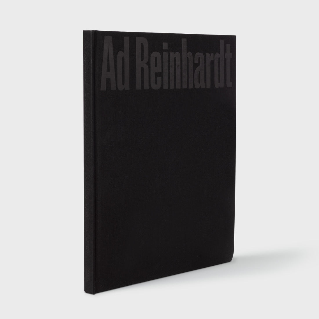 Ad Reinhardt: Color Out of Darkness, Curated by James Turrell book standing upright. Black cloth cover with black text.