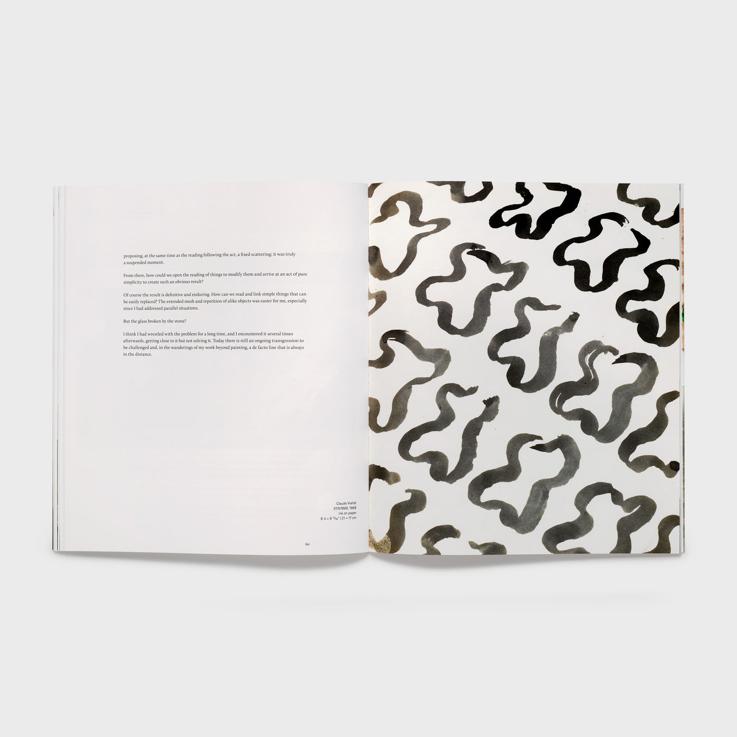The book is open to two pages. The right page has a black and white Claude Viallat work and the left page has an essay.