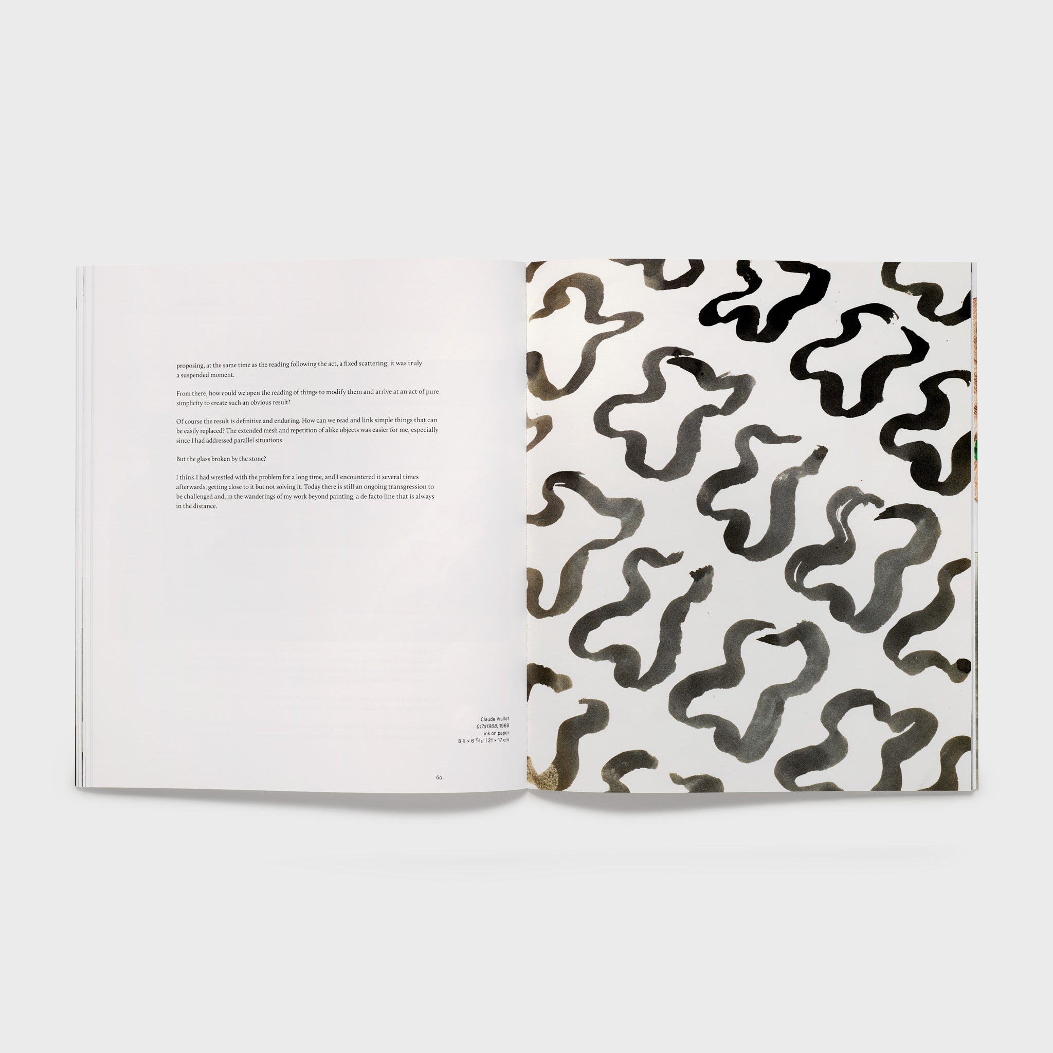 The book is open to two pages. The right page has a black and white Claude Viallat work and the left page has an essay.
