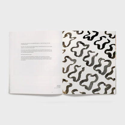 The book is open to two pages. The right page has a black and white Claude Viallat work and the left page has an essay.