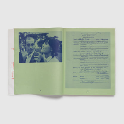 The book is open to two pages. The paper is green with blue photos printed on it.