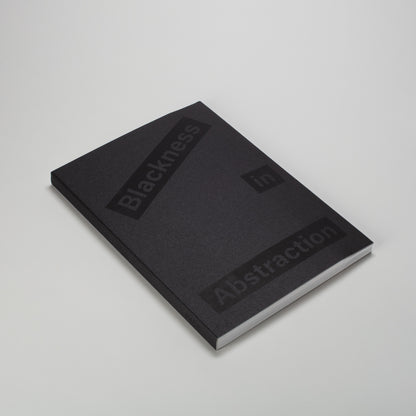 Blackness in Abstraction. The book is laying flat and has a black cloth cover with black font.