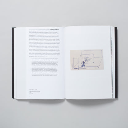 The book is open to two pages. The left page has an essay about Wangechi Mutu and the right page has an image of her drawing.