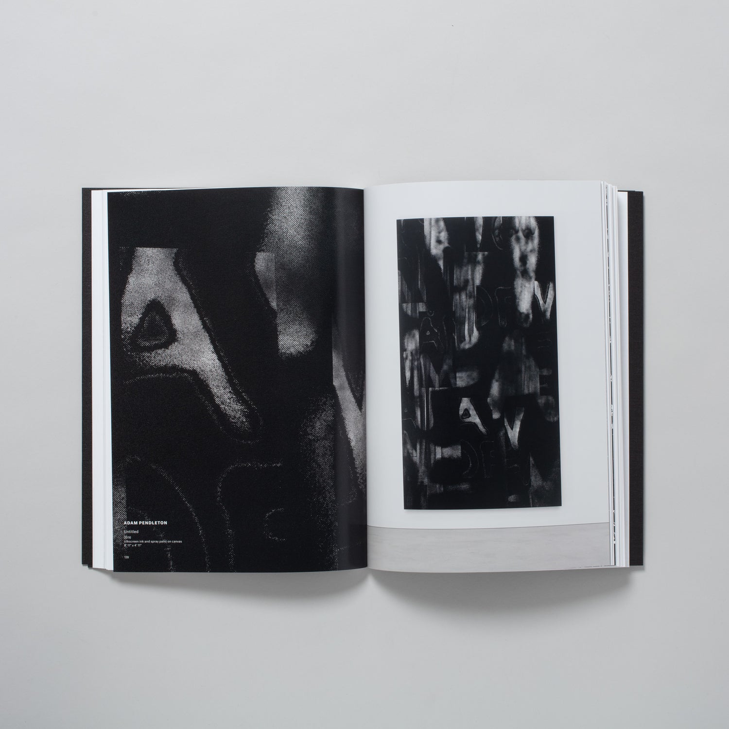 The book is open to two pages with an image of a black and white work by Adam Pendleton on the right page. The left page has a close up image of the same work.