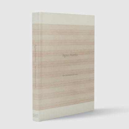 Agnes Martin The Distillation of Color. The book has a pink striped Agnes Martin work covering the cloth cover.
