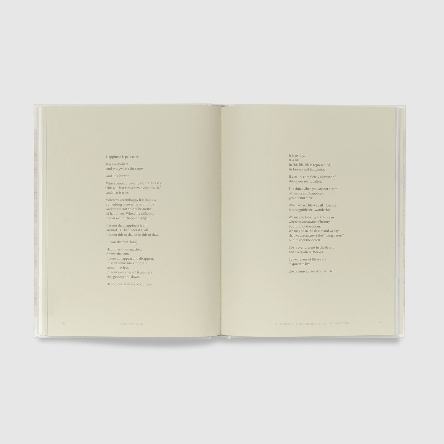 The book is open to two pages that have a poem across both written in black text.