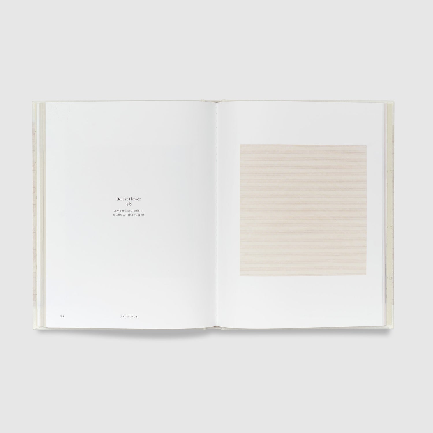 The book is open to two pages. The right page features the Agnes Martin work Desert Flower and the left page has black text describing the work.