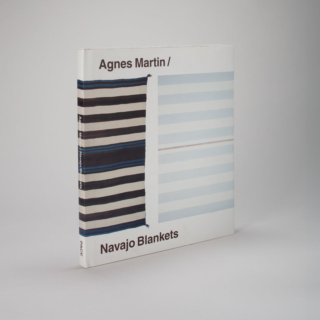 Agnes Martin Navajo Blankets. The book is standing upright and the book features a Navajo Blanket next to an Agnes Martin painting. 
