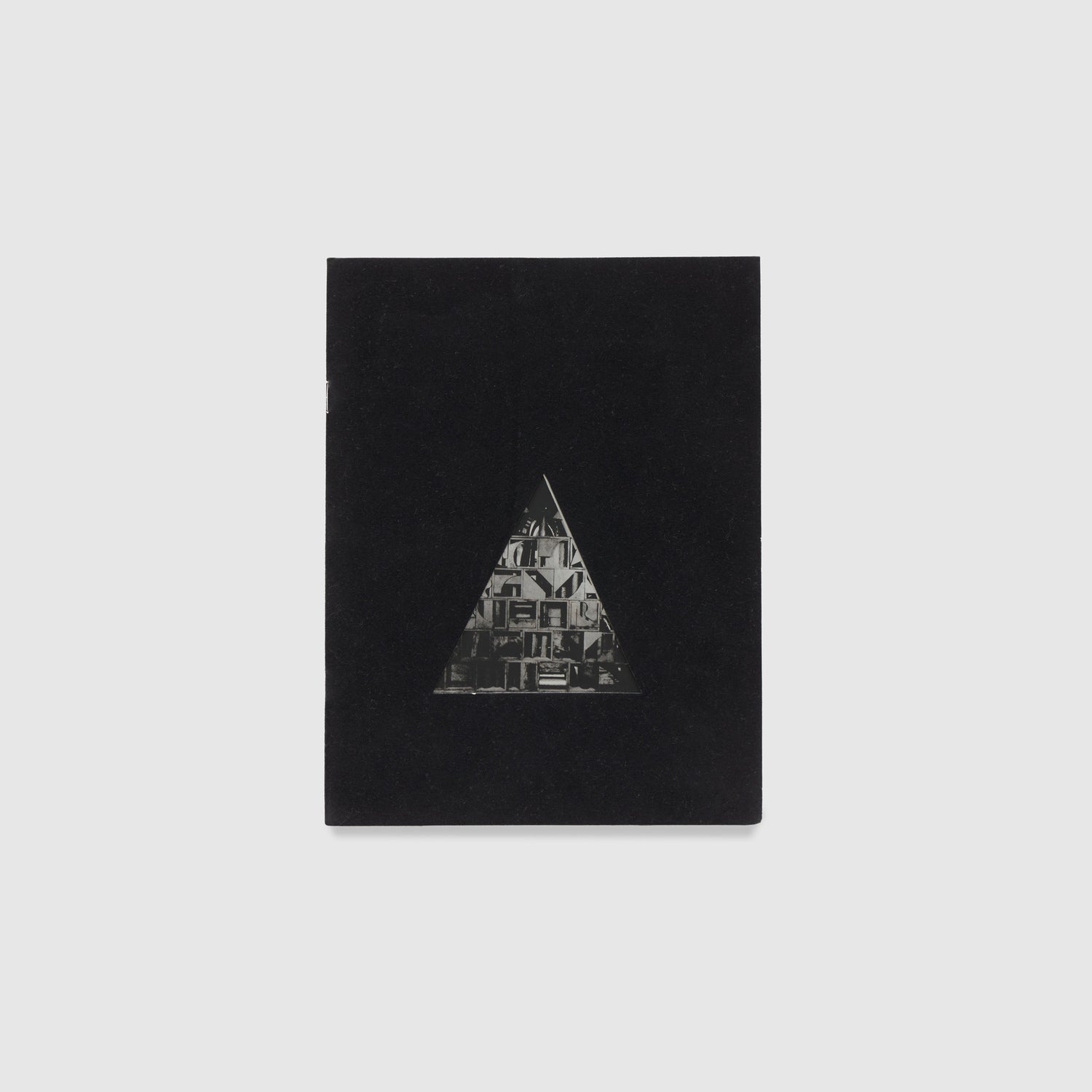 The cover is black with a triangle that has a black and white Nevelson work inside of it.