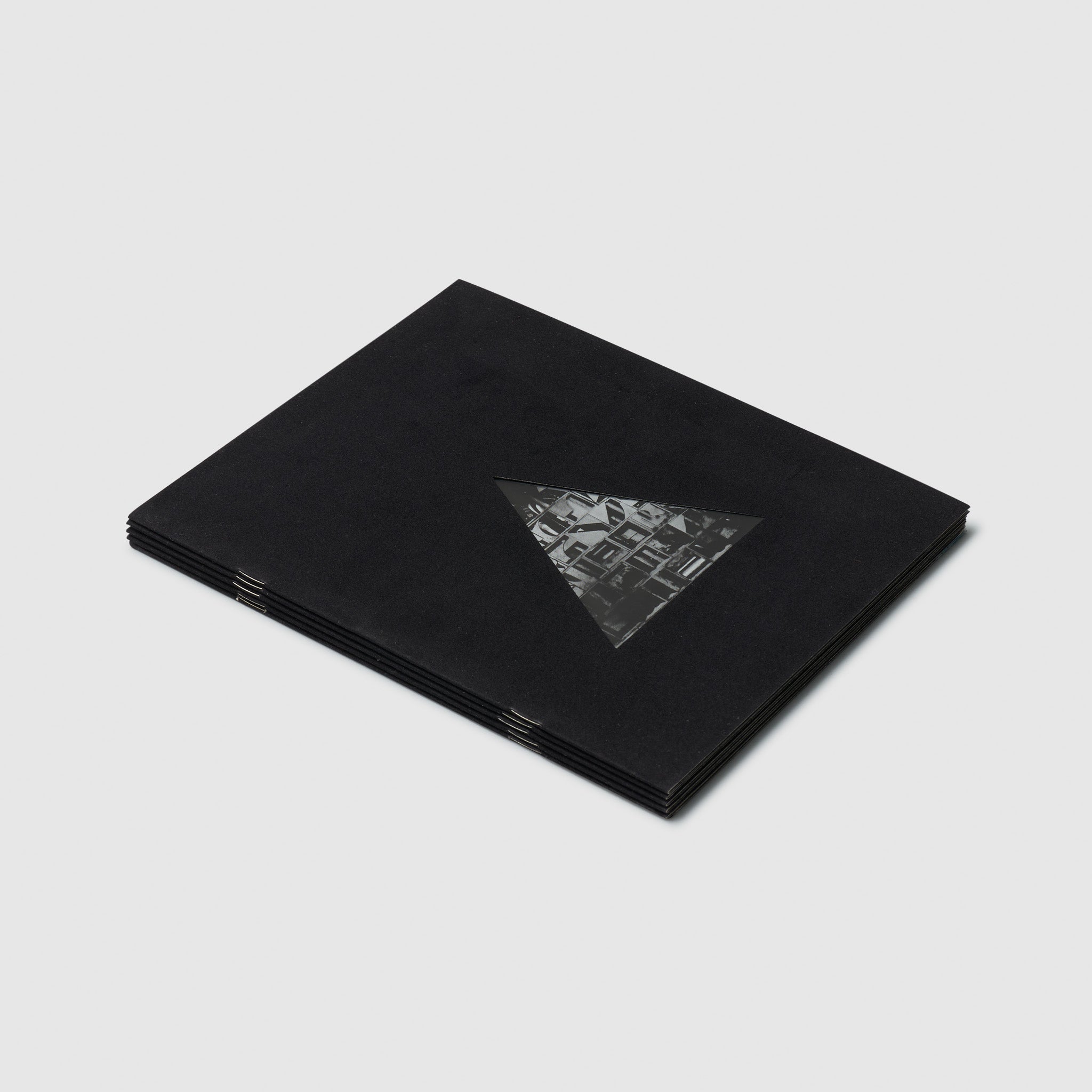The cover is black with a triangle that has a black and white Nevelson work inside of it.