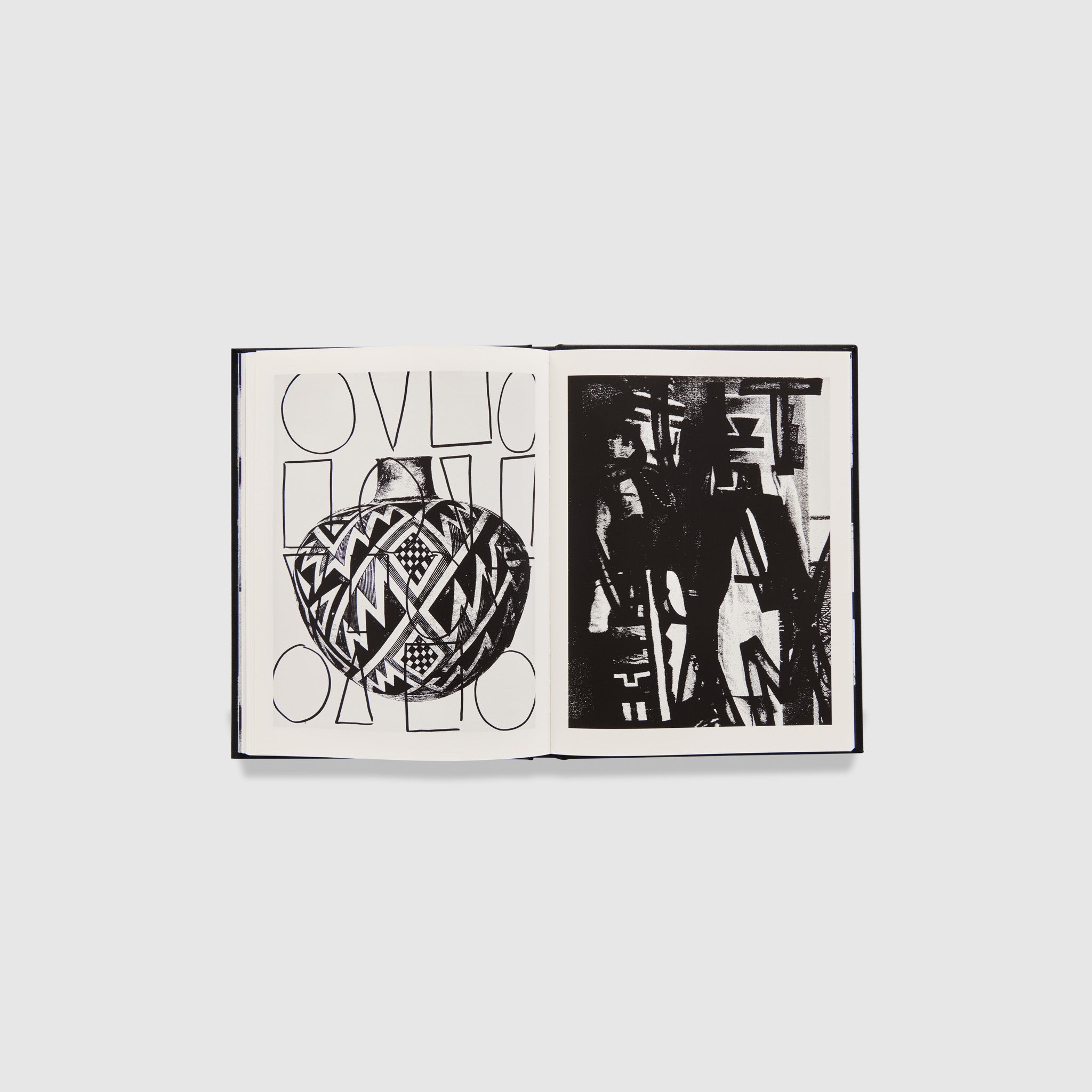 The book is open to two pages with the artists black and white works on both pages.