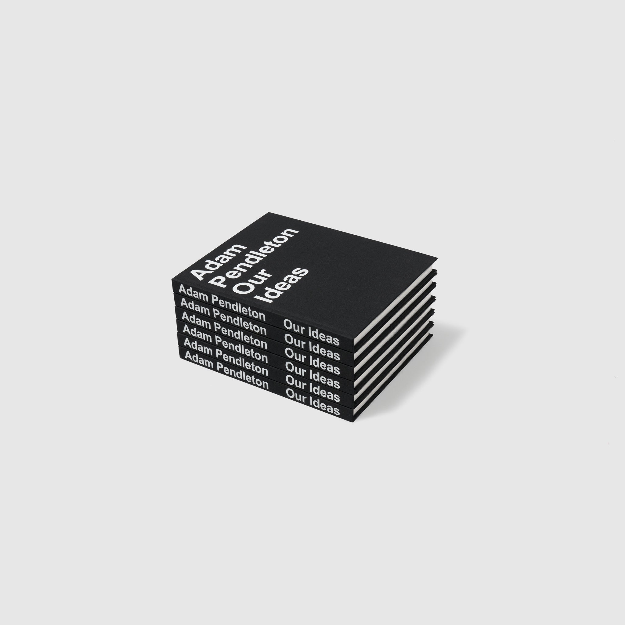 Adam Pendleton Our Ideas by Suzanne Hudson, Alec Mapes-Francis, Yvonne Rainer, and Adam Pendleton. There is a pile of six of the books.