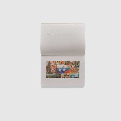 The book is rotated and open to two pages. The bottom page has an image of the artist&
