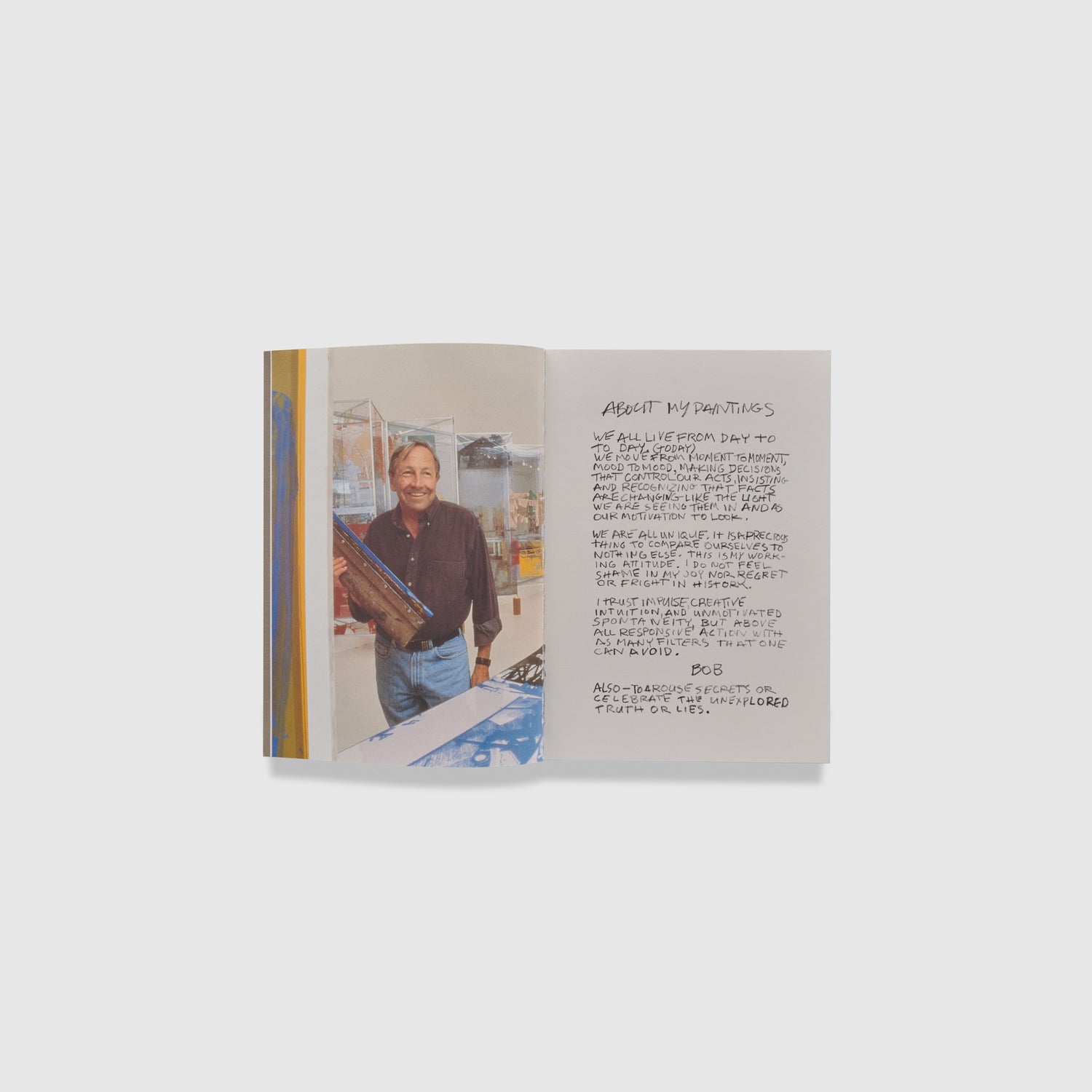 The book is open to two pages. The left page has a portrait of the artist in his studio and the right page is a handwritten note from the artist.