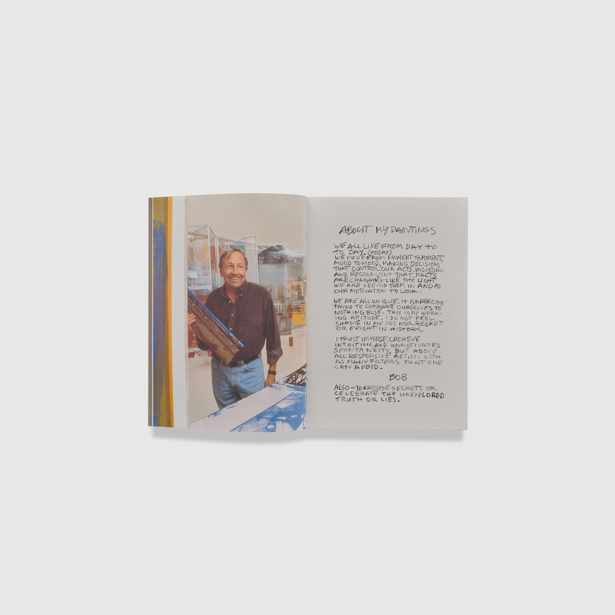 The book is open to two pages. The left page has a portrait of the artist in his studio and the right page is a handwritten note from the artist.