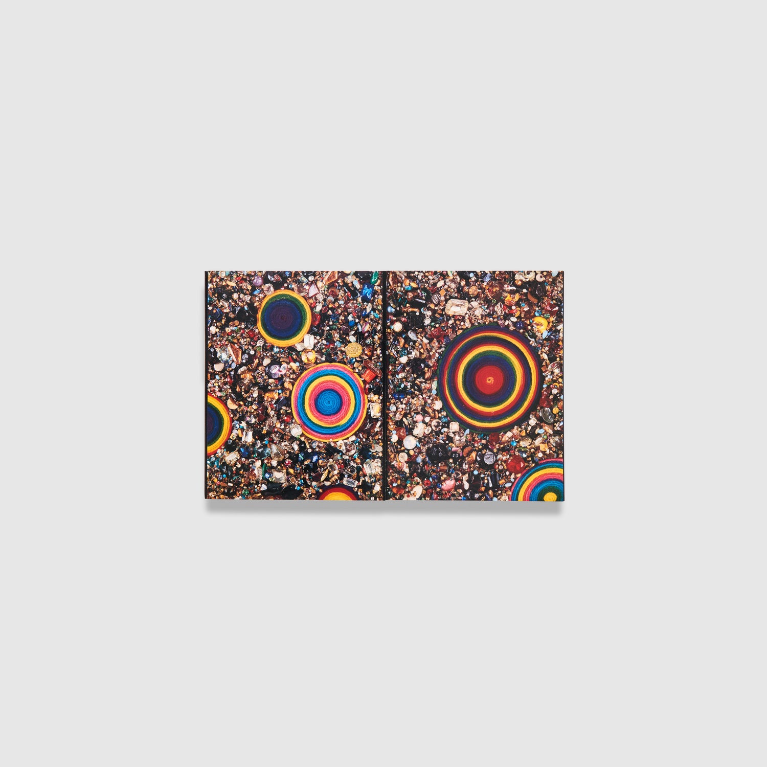 The cover has a colorful Samaras work with beads, jewels, and rainbow circles. The book opens like a box.