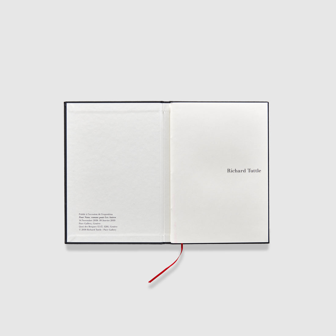 The book is open to two pages. The right page is the first page of the book and the left pages has the publication information.